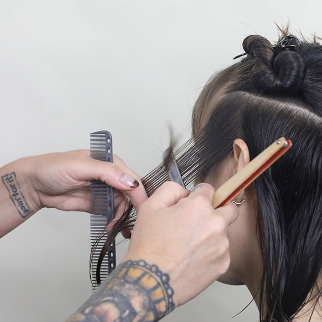 Close-up photo of women cutting hair