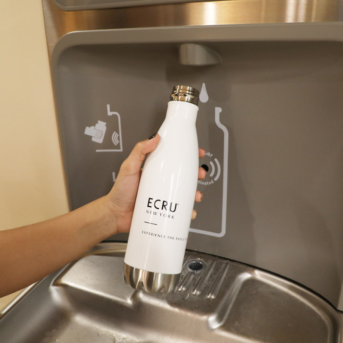 Photo of person filling up water with bottle